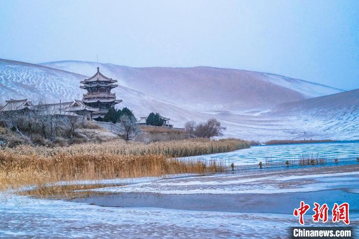 2021年11月28日，雪落鳴沙山月牙泉景區(qū)?！⊥醣筱y 攝